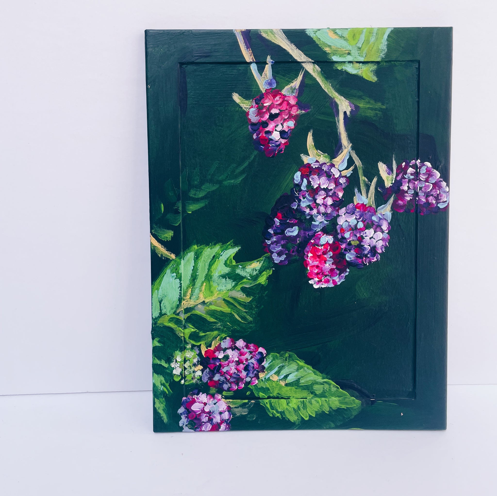 raspberry painting, dark and moody background on a vintage frame