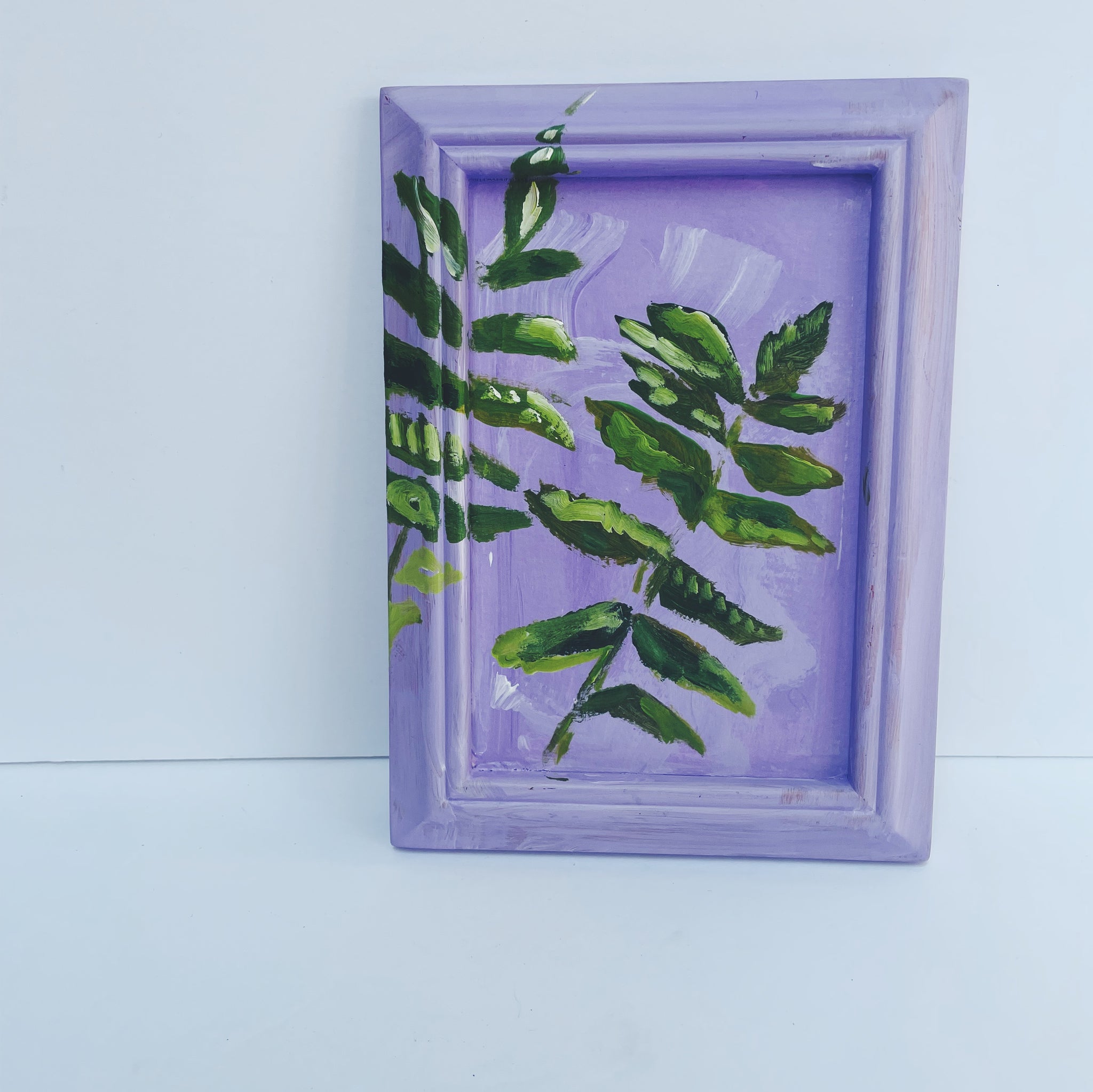 purple painting on vintage, reclaimed frame of vibrant green leaves abstracted in acrylic paint